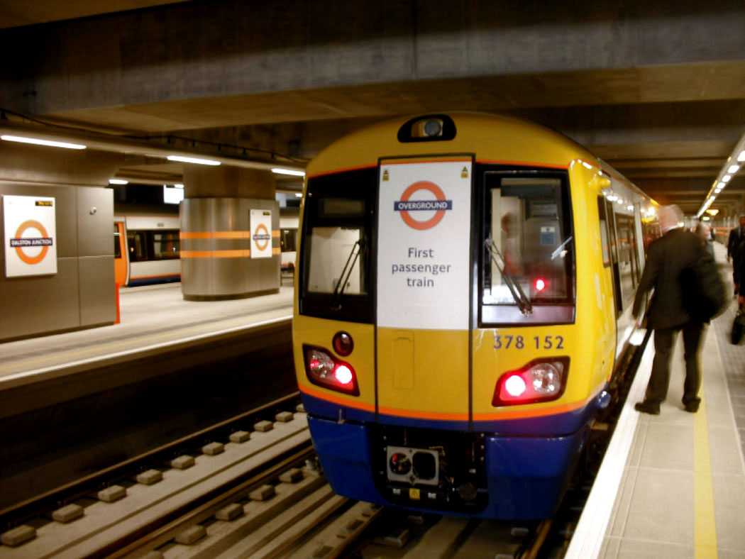 Close-up of a London Overground train at Dalston Junction station, marked 